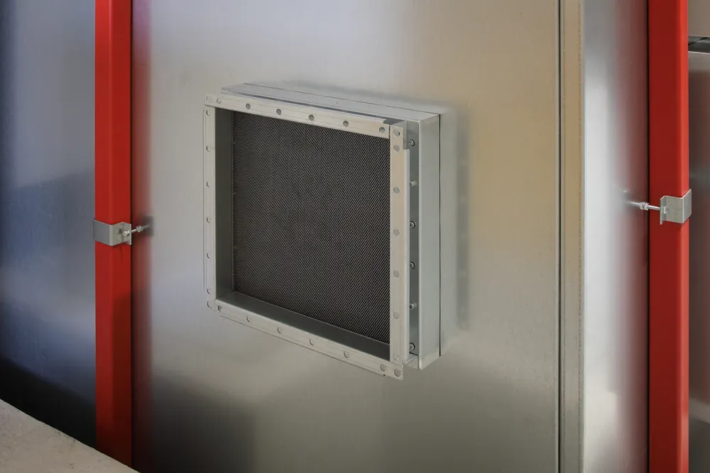Honeycomb ventilation waveguide panel mounted into a shielded wall