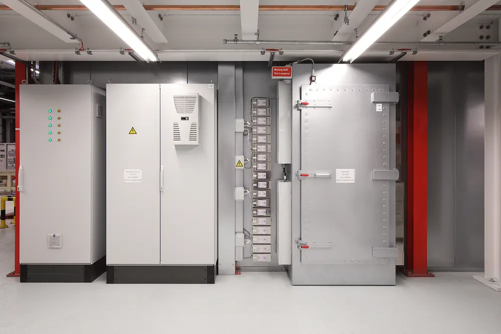 Filter cabinets beside an opened power line filter bank at the shielding boundary