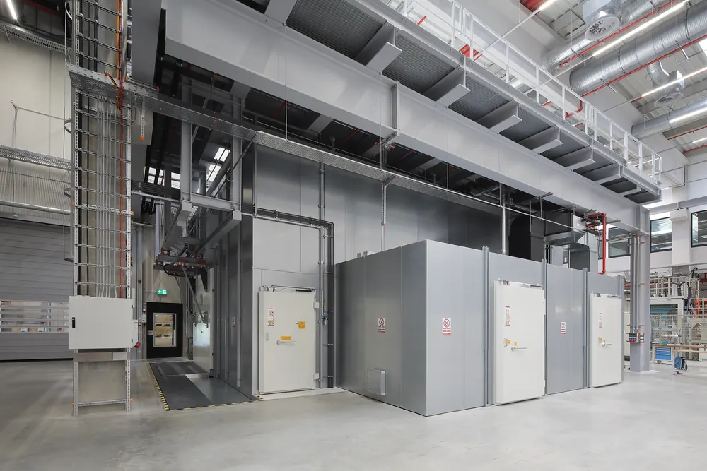 A hall of installed shielded rooms with access platform and stairs