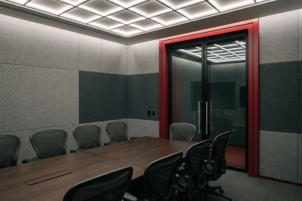 Shielded boardroom with acoustic wall panels and a glass-and-steel RF door